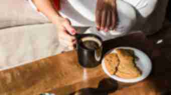 Coffee being enjoyed with a large cookie