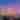 Lexington city skyline lit up for nighttime as the sun sets. The sky is blue and pink.